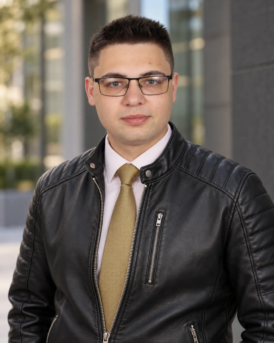 Alex Tsvetanov wearing a leather jacket and gold tie
